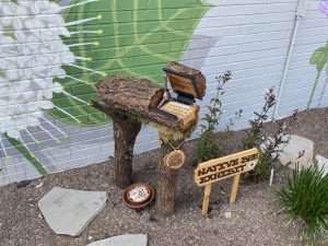 Spriggly's Native Bee Exhibit Exhibit located in Hendersonville, NC. This interactive exhibit is placed in front of the Good of the Hive Mural.